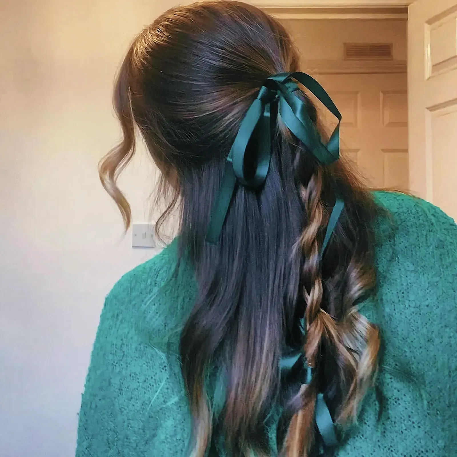 Fashionable woman with elaborate hairstyle and green bow hair accessory