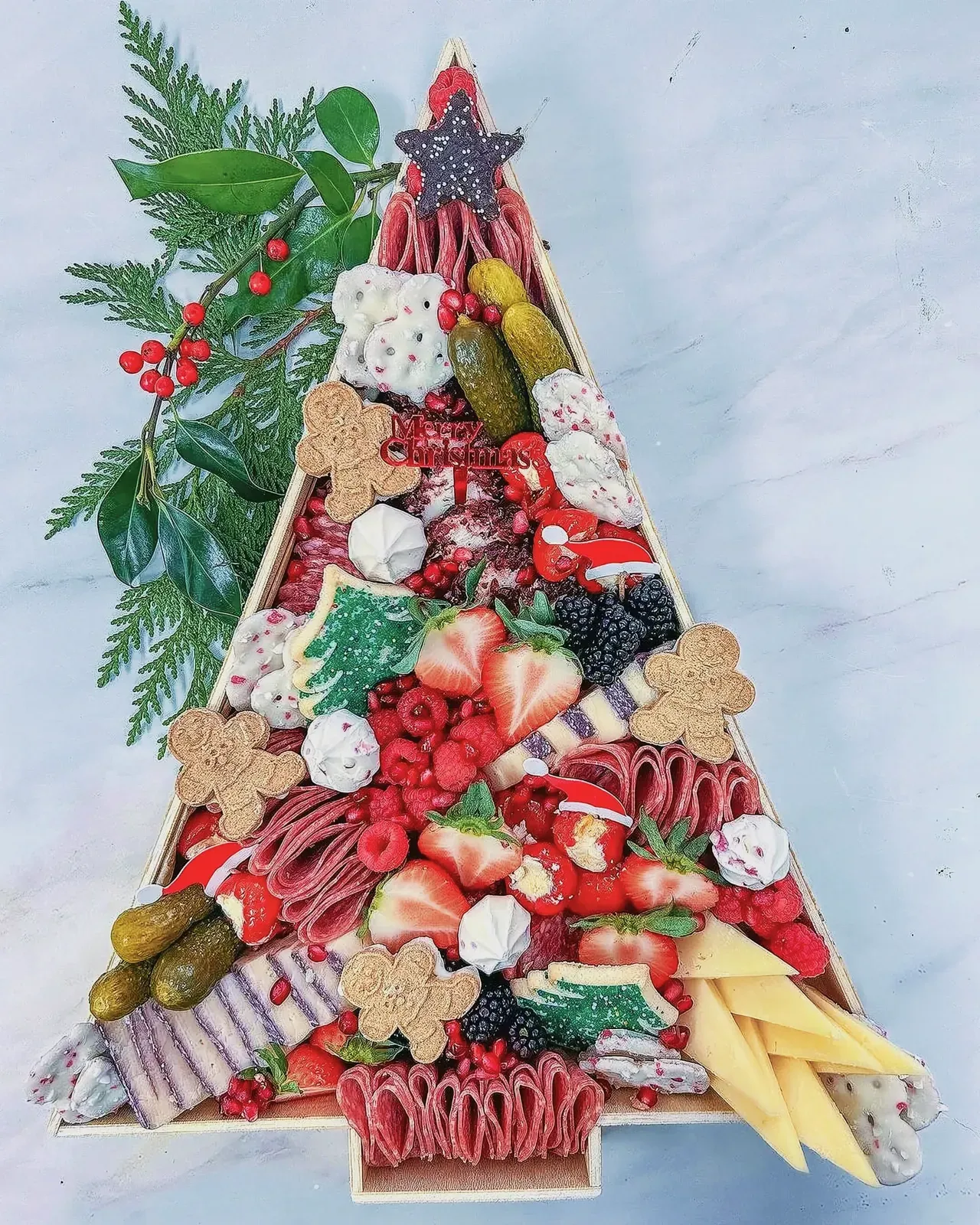 Christmas Tree charcuterie with an assortment of fruits, veggies, cheeses, and meats.