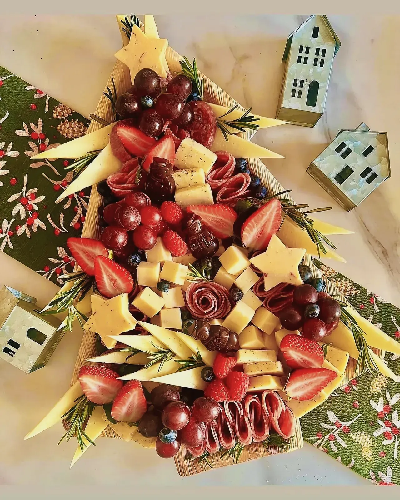 A plate filled with fruits and cheese, perfect for Christmas finger foods.