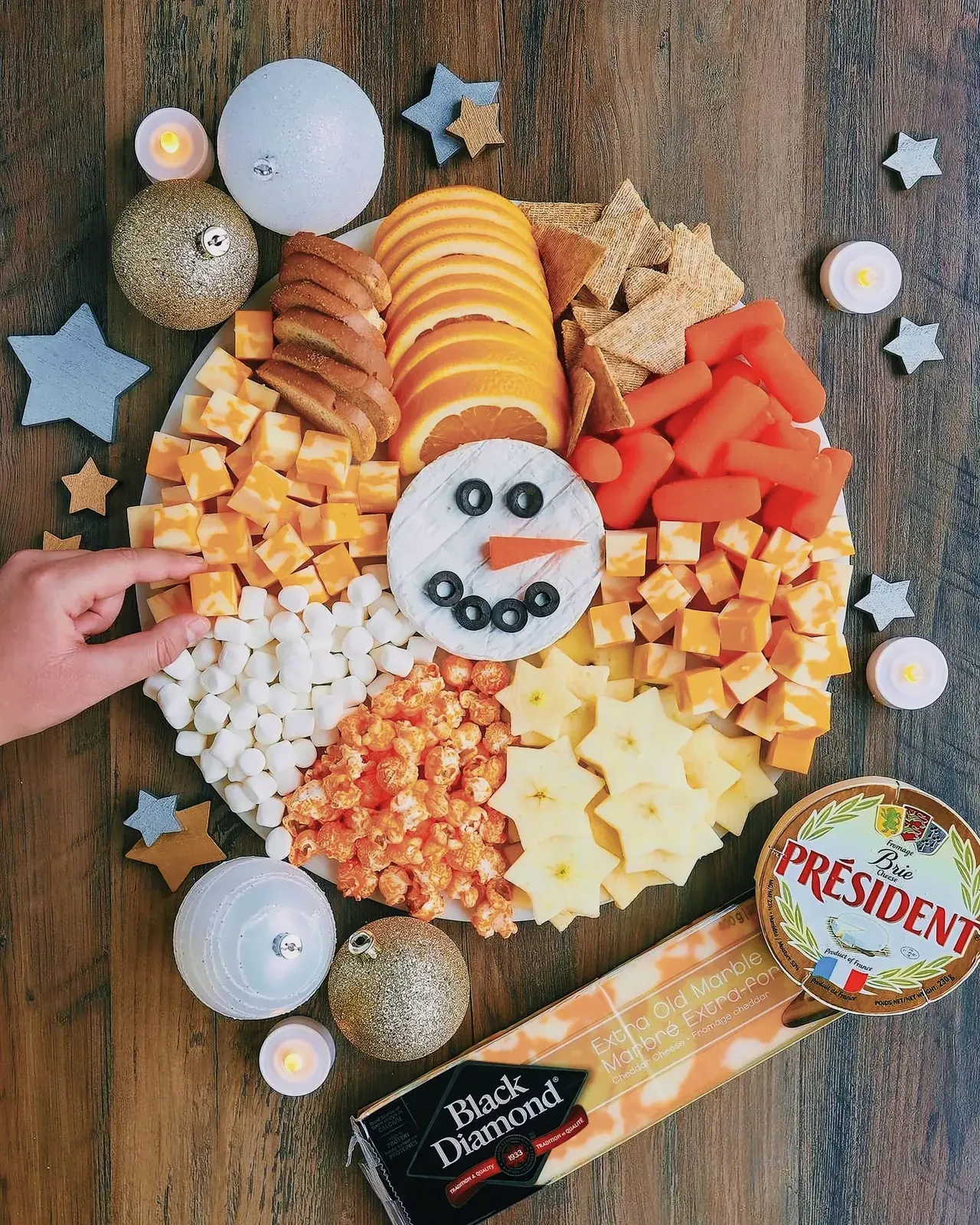 Delightful snowman-themed grazing platter with vegetables, cheese, and snacks