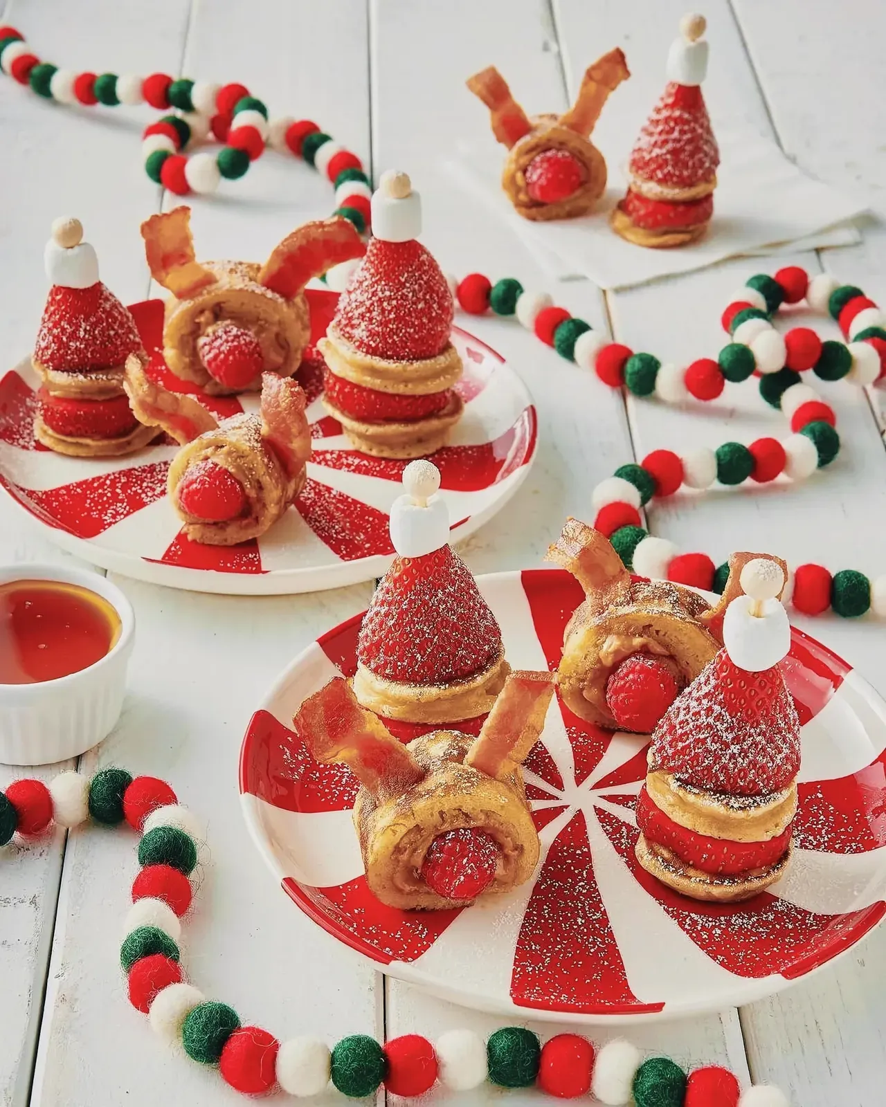 Delightful Christmas finger foods displayed on a red and white striped plate.