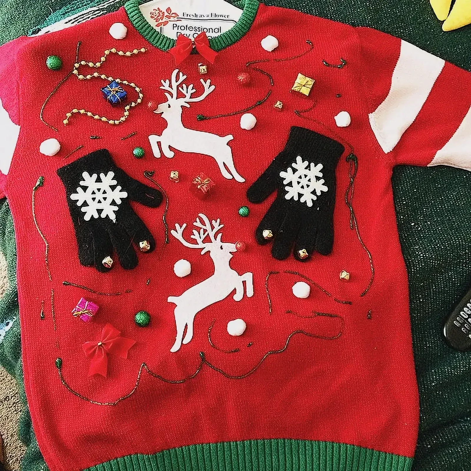 Festive red and green Christmas sweater with reindeer pattern.