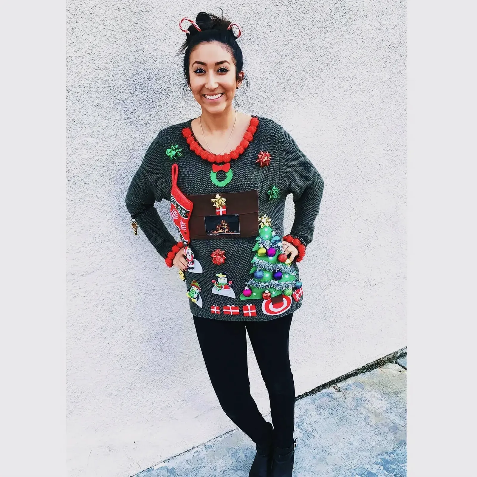 Woman wearing a trendy Christmas sweater with festive decorations