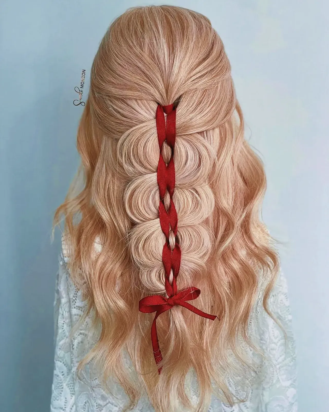 Close-up of a woman with a festive Christmas braid hairstyle