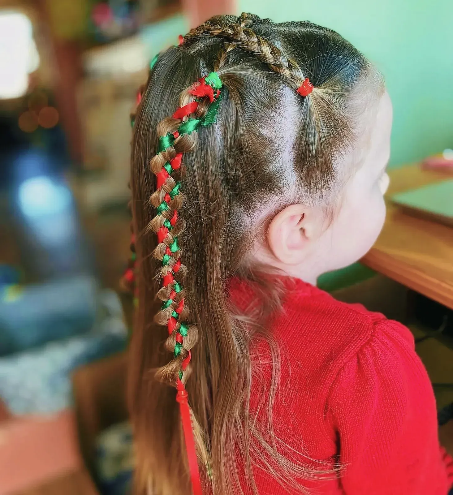Young girl with elegant braided hairstyle and ribbons