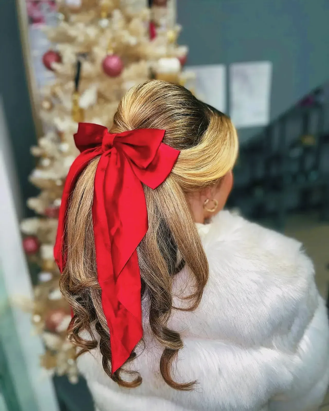 Stylish woman with a vibrant red bow in her hair