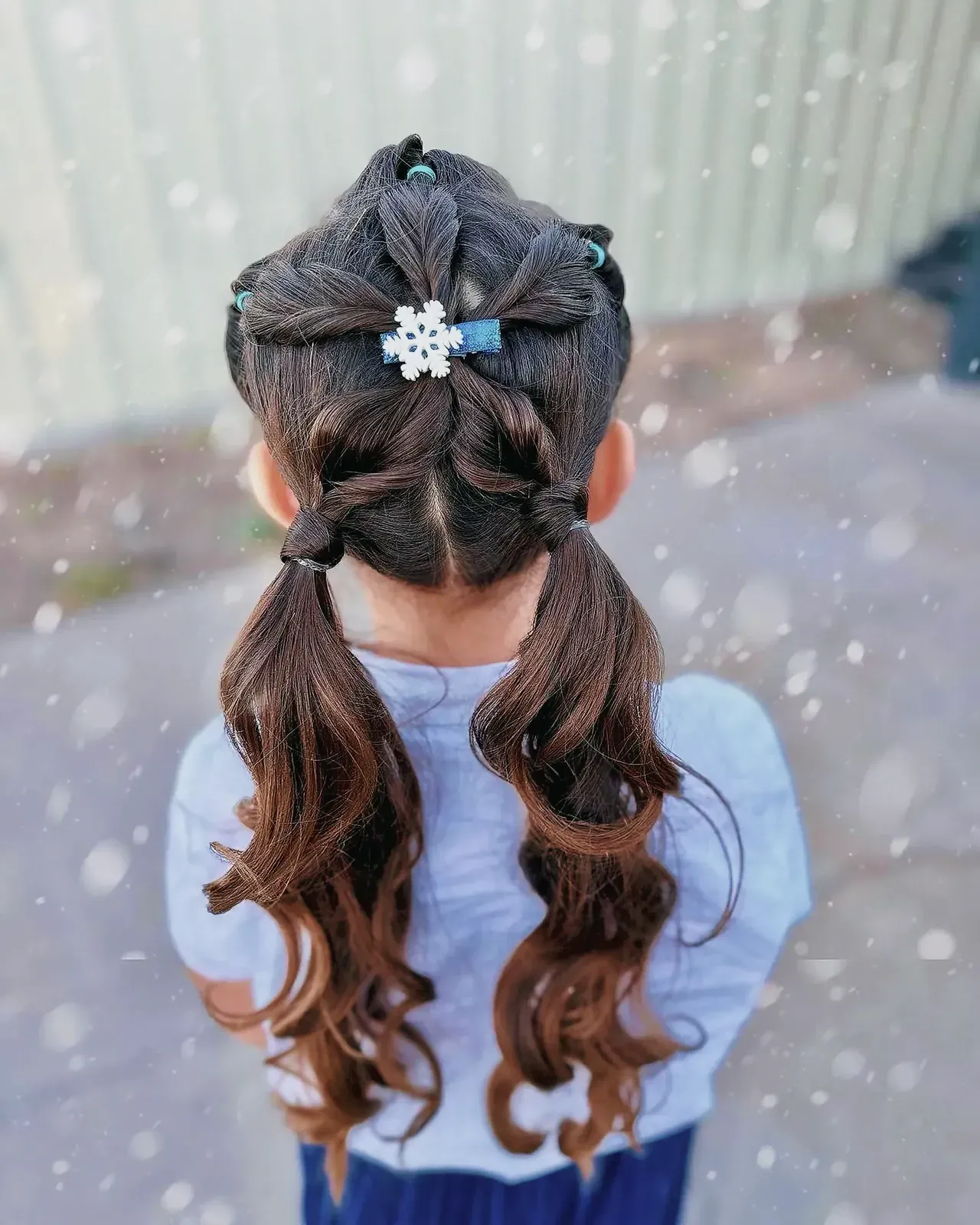 Young woman with snowflake hair clip in a winter wonderland hairstyle.