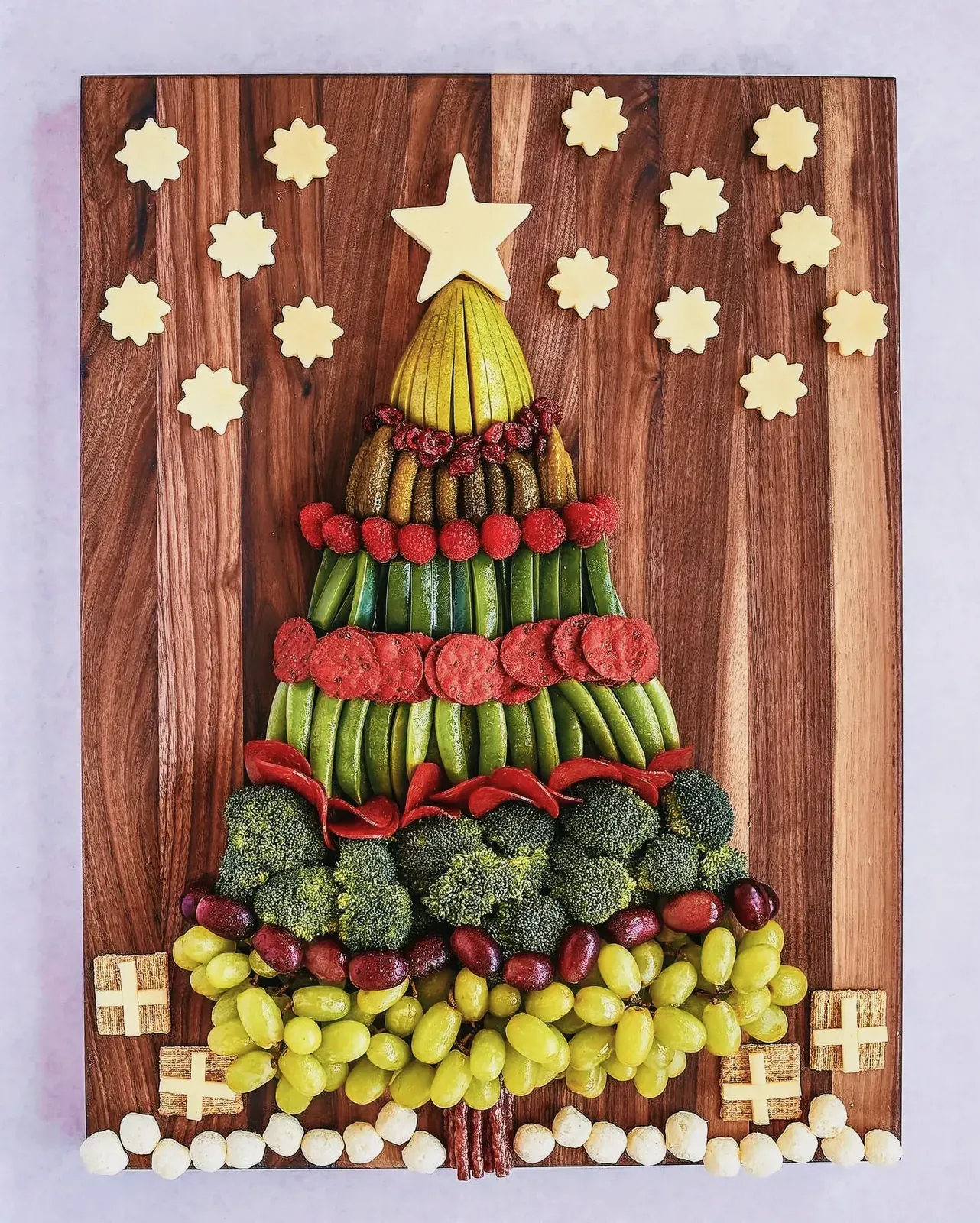 Christmas Tree Snack Board on wooden board with various festive finger foods