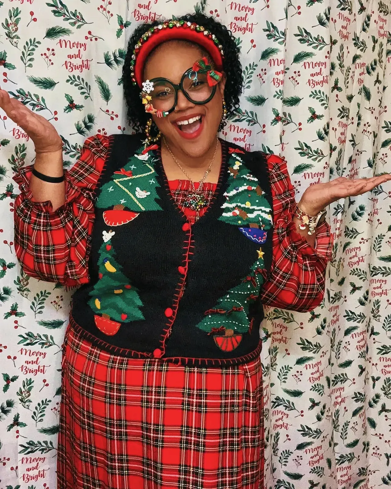 Woman wearing a Christmas-themed sweater with a tartan pattern and glasses