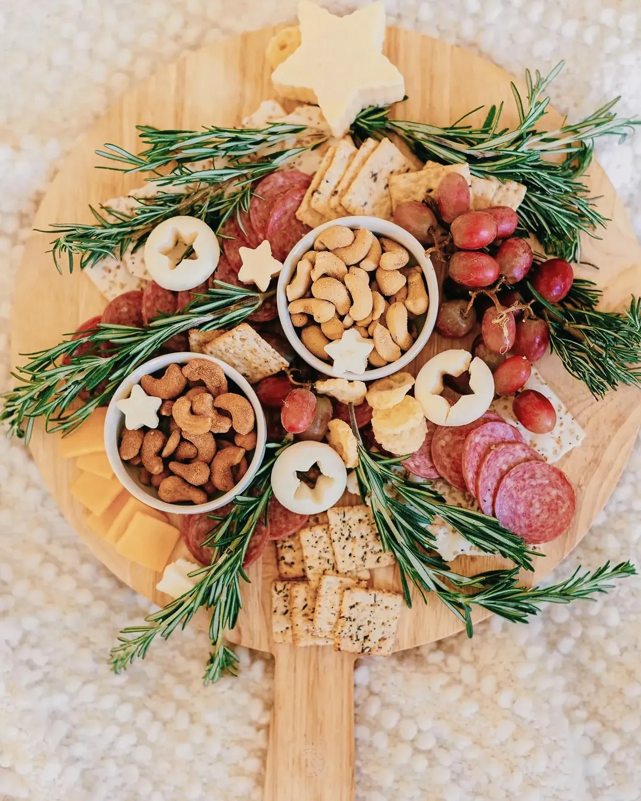 Christmas charcuterie tree with an assortment of cheeses, meats, and fruits.