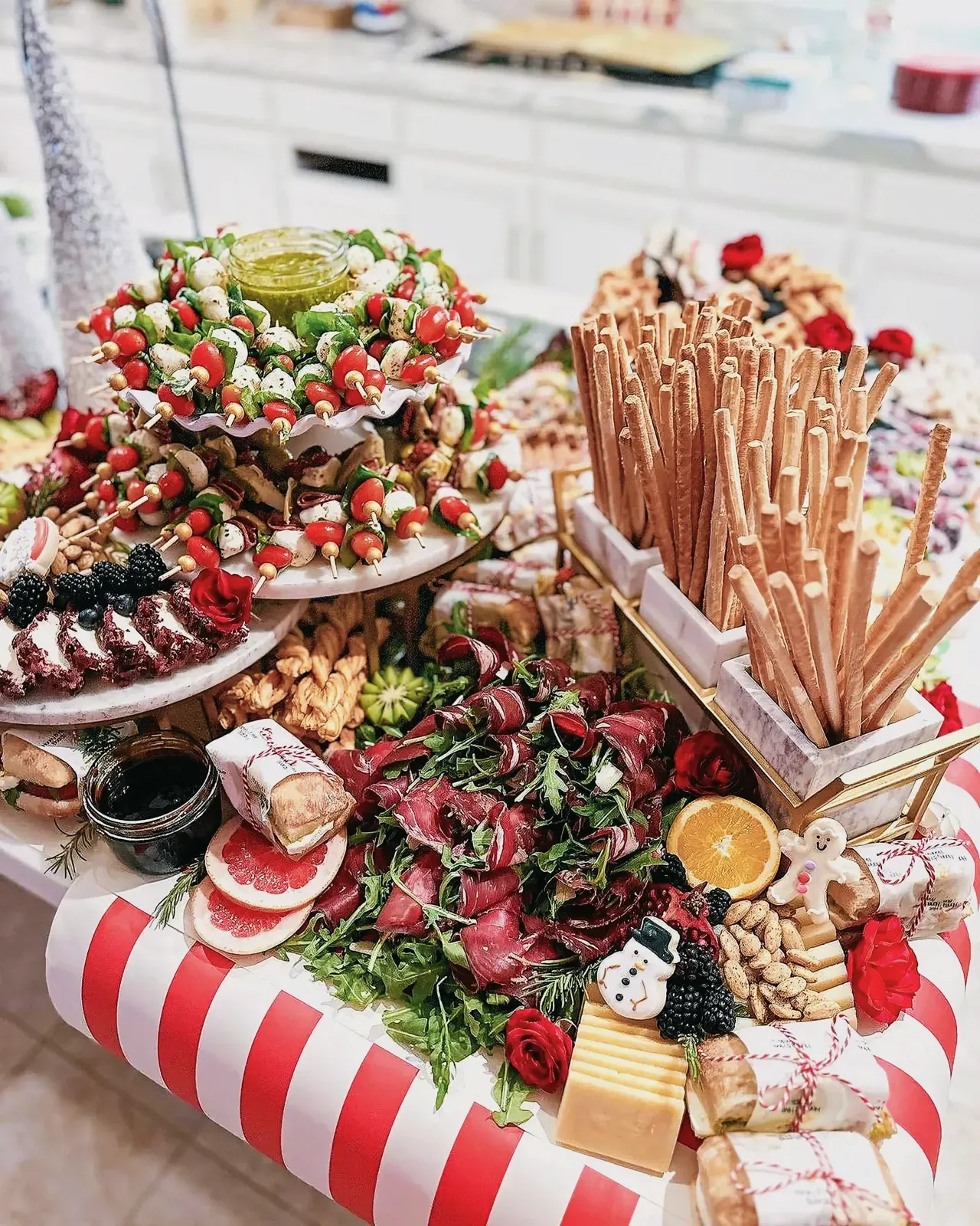A festive feast of finger foods and holiday-themed snacks on a beautifully decorated table.