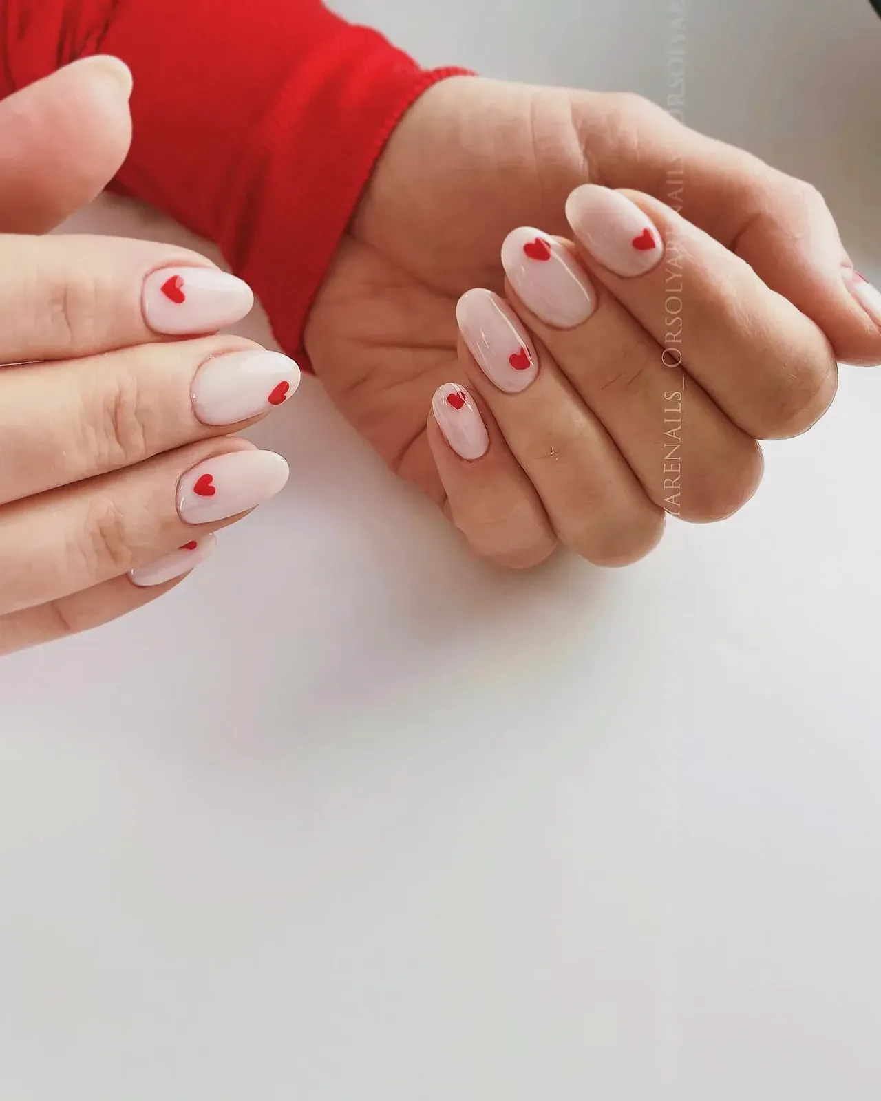 Intricately painted fingernails featuring a heart design on one nail