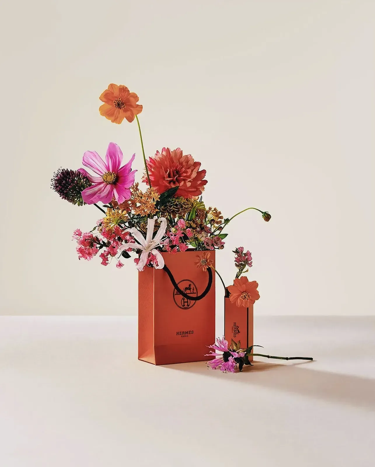 Vibrantly orange Hermes bag with floral pattern