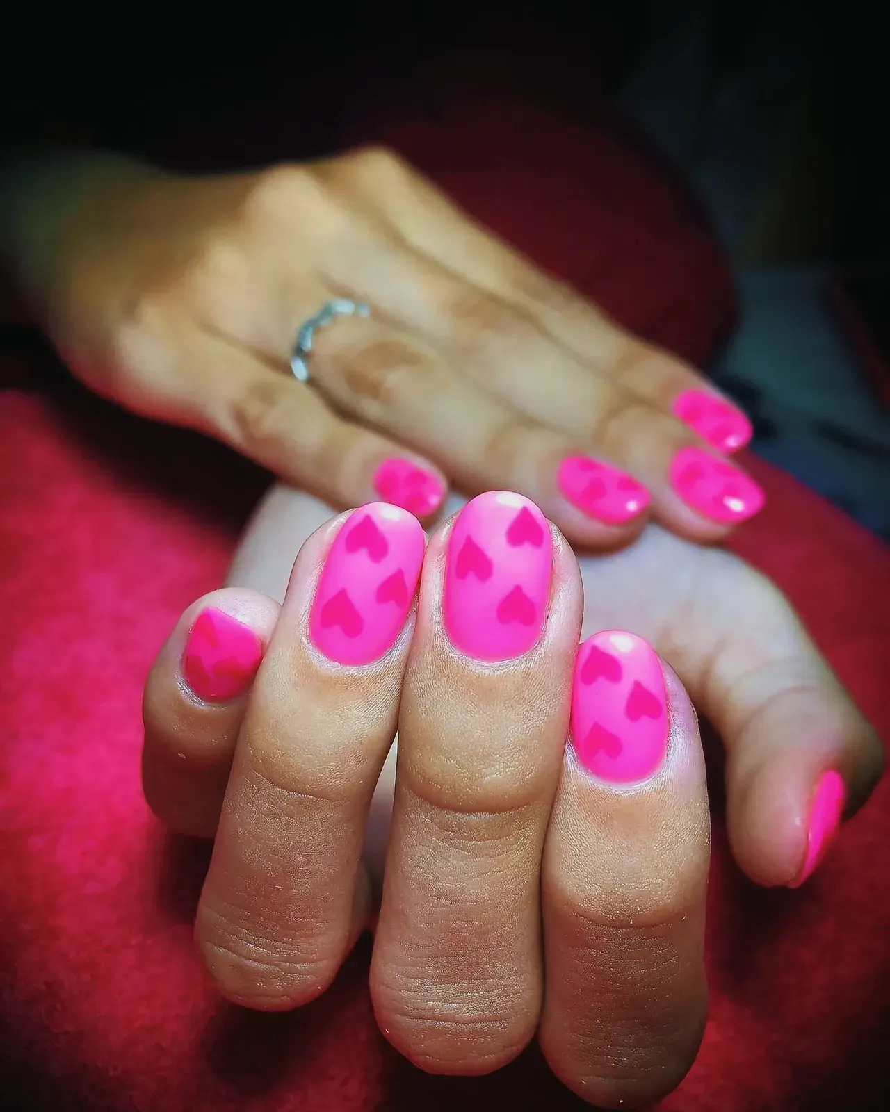 Close-up shot of beautifully manicured nails painted in vibrant pink