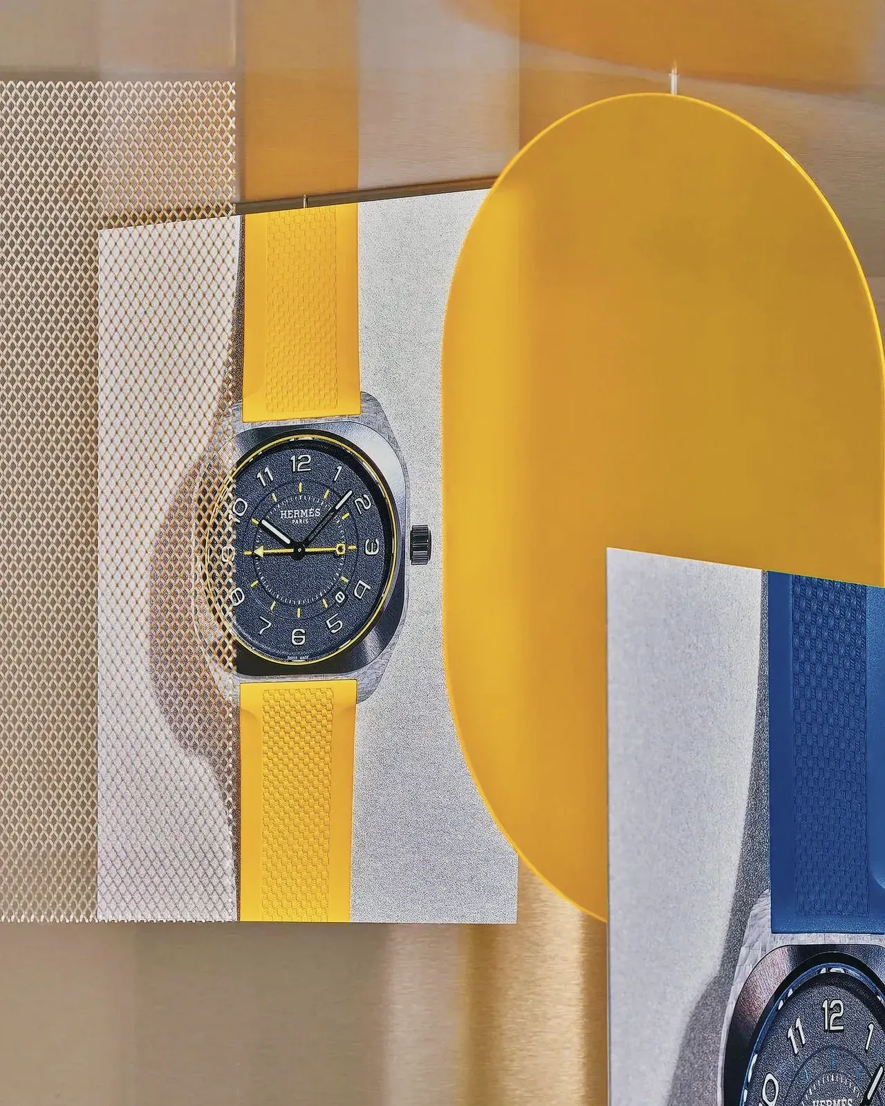 Close-up view of a stylish Hermès H08 wristwatch on a dual-colored surface.