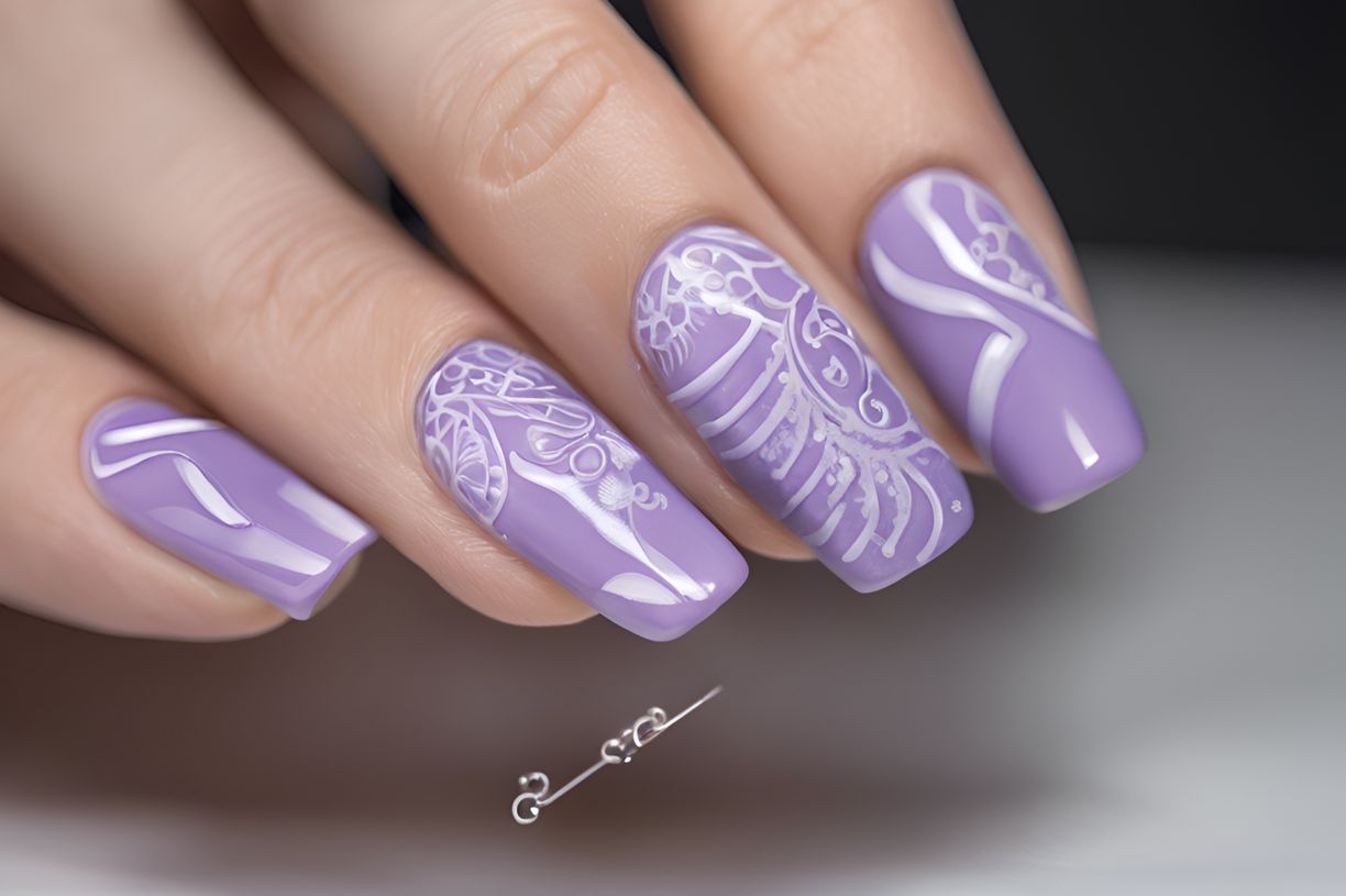 Hand with light purple nails holding a nail art brush