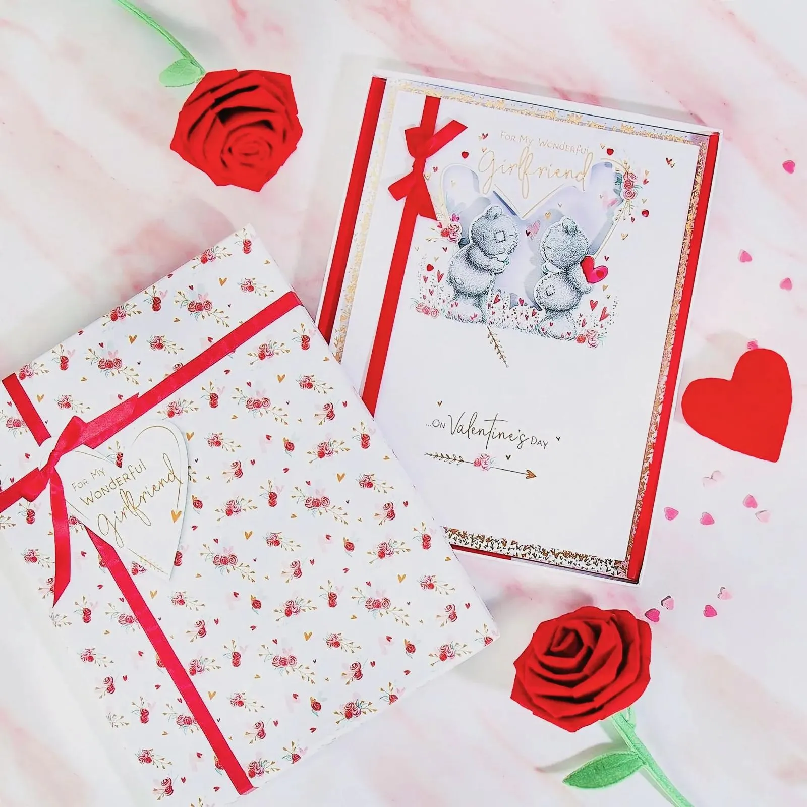 Valentine's Day gift boxes and roses on a marble surface