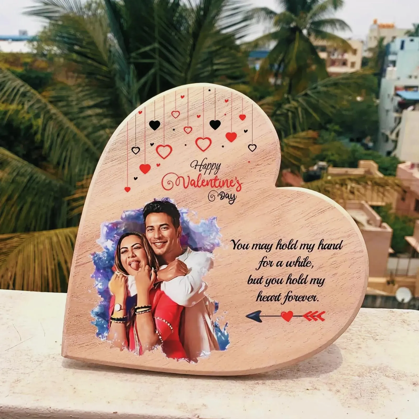 Wooden heart-shaped frame with a photograph of a man and woman